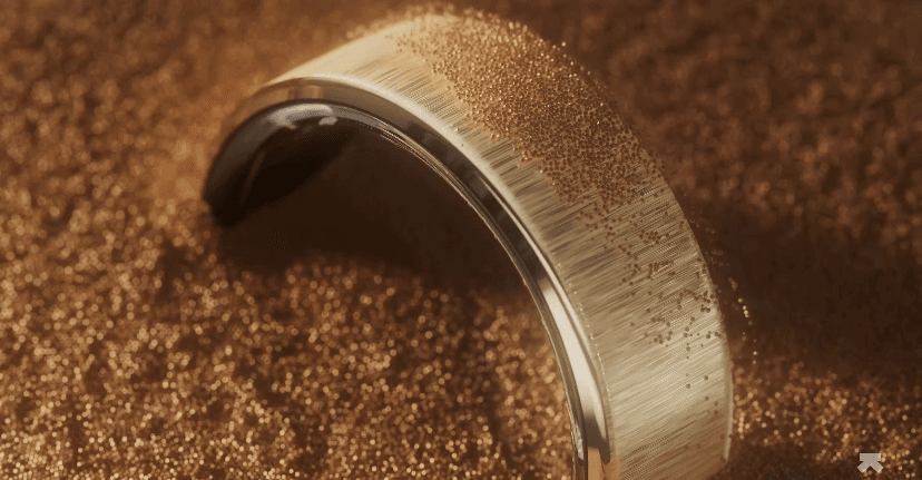 A gold ring with a black center

Description automatically generated